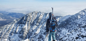 Skier atop Mt Katahdin looking at Chimney Couloir