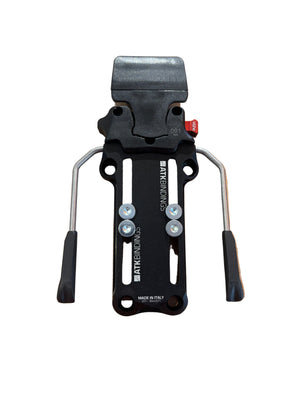 Black ski binding on a cardboard box held by a hand