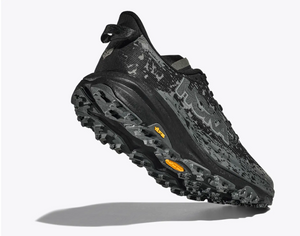 Black and gray trail running shoe with unique tread pattern on a white background