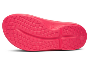 Close-up of a pink shoe sole with tread pattern on a white background