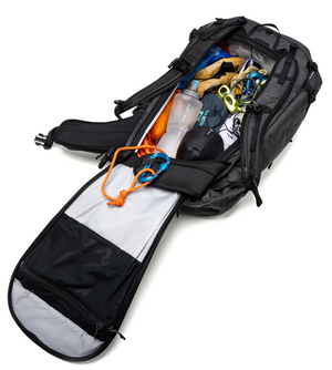 Open backpack with various items on a white background