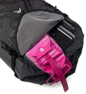 Black backpack with a pink item inside on a white background