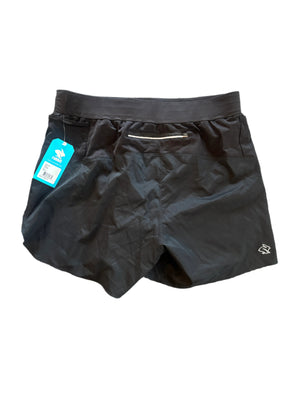 Black shorts with a tag on a gray textured surface