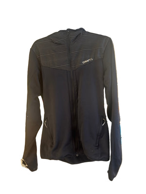 Black backpack on a textured surface with a blurred background