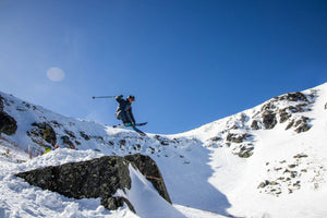 Skier jumping over rock in Tuckerman Ravine, Mount Washington